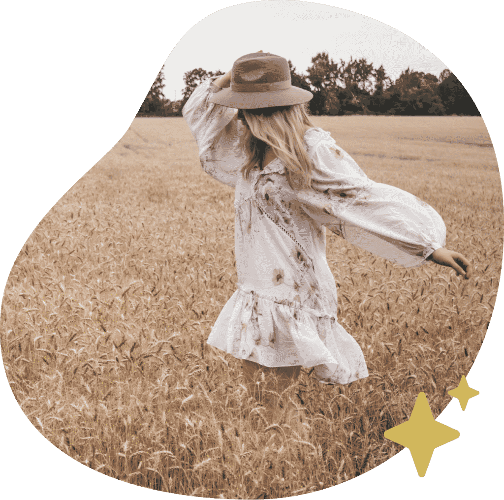 woman walking freely in a field after a successful business coaching session